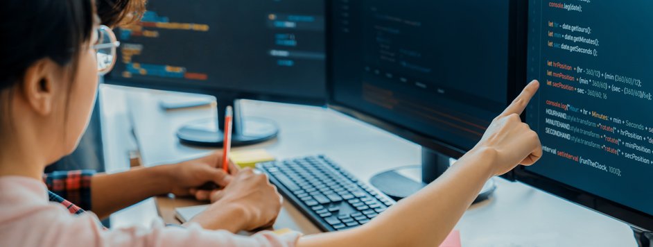 female programmer taking notes during work